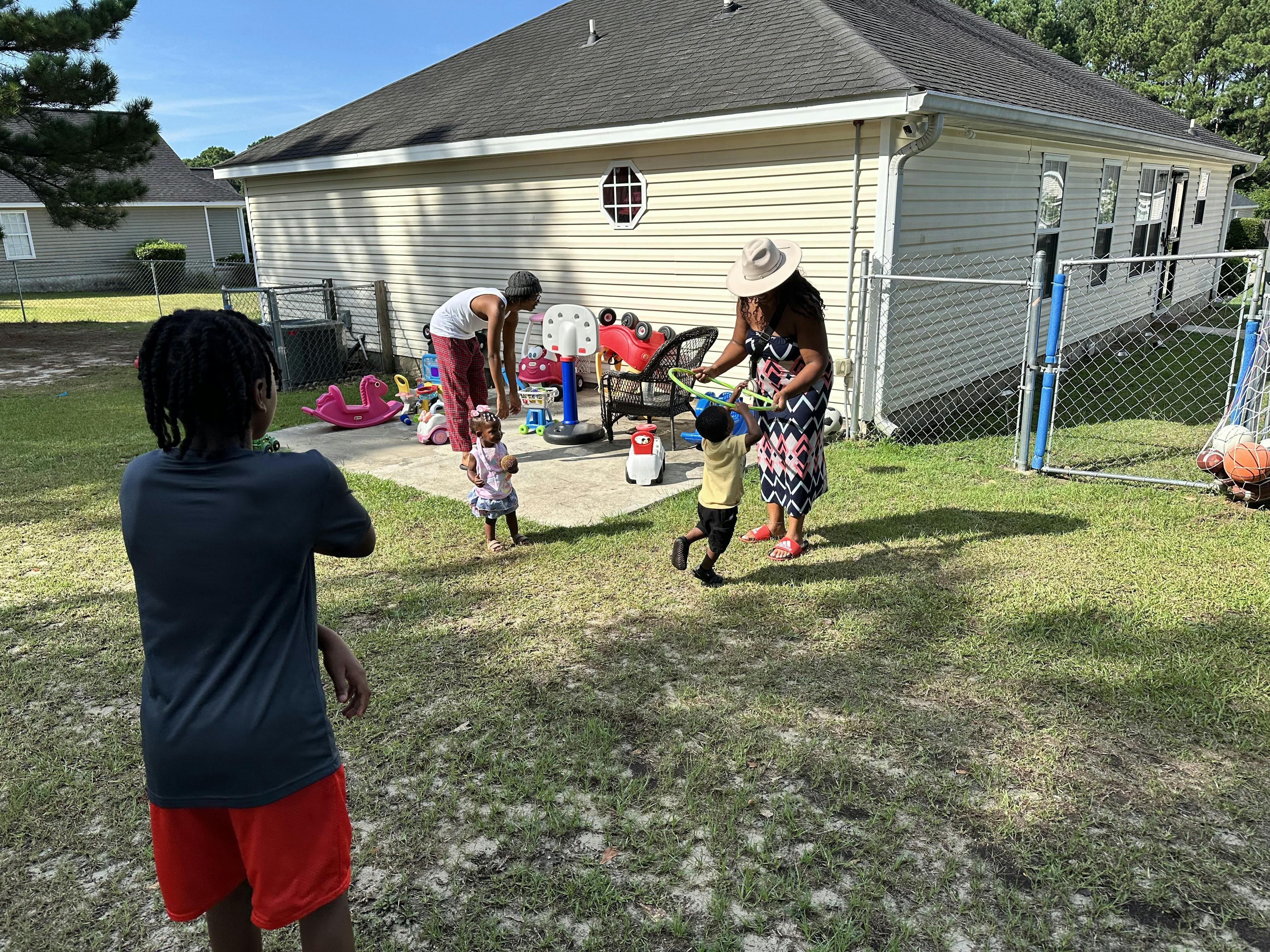 People and children in a yard