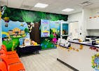 Children's play area with jungle-themed wall decorations