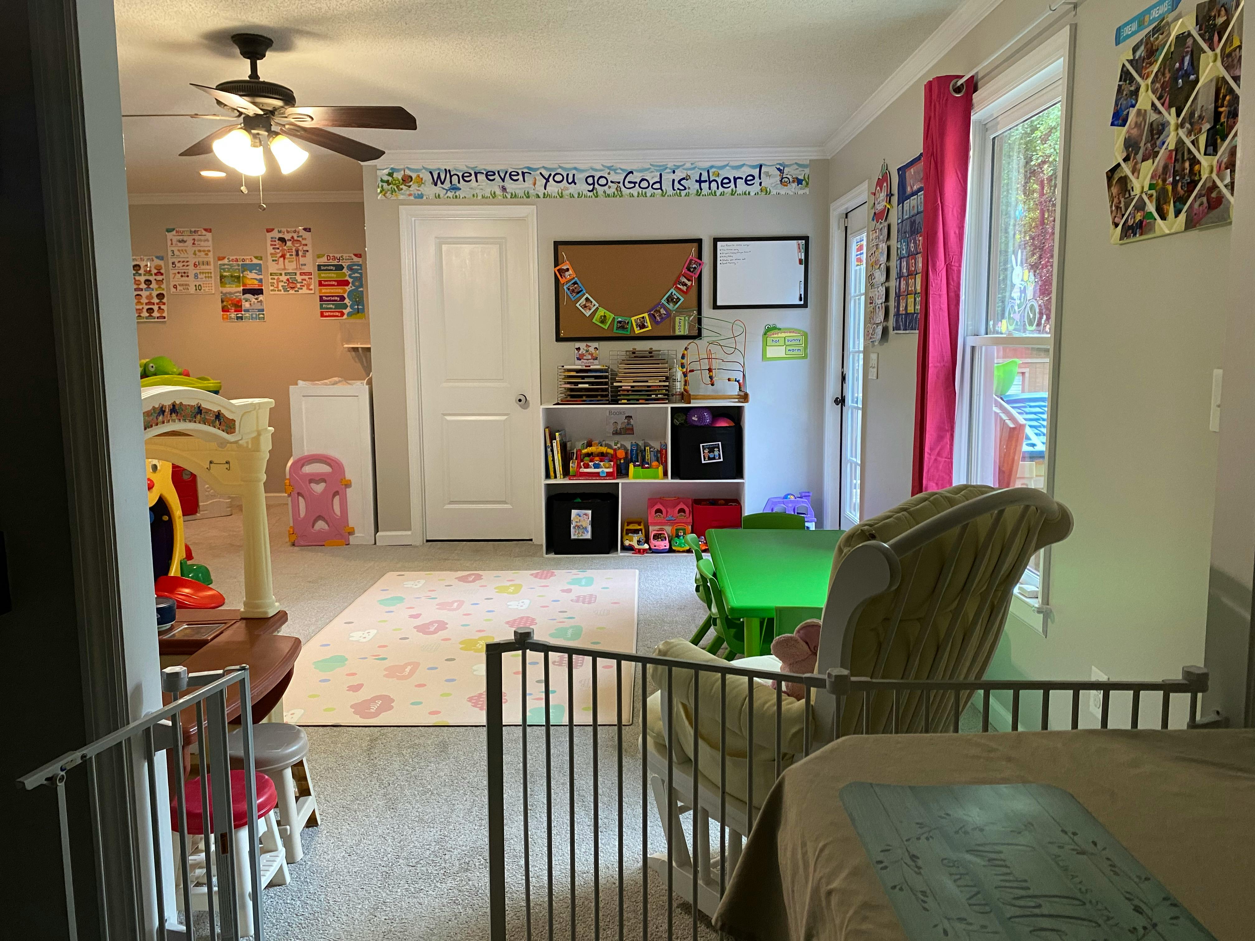 Playroom with toys, child-sized furniture, and a baby gate