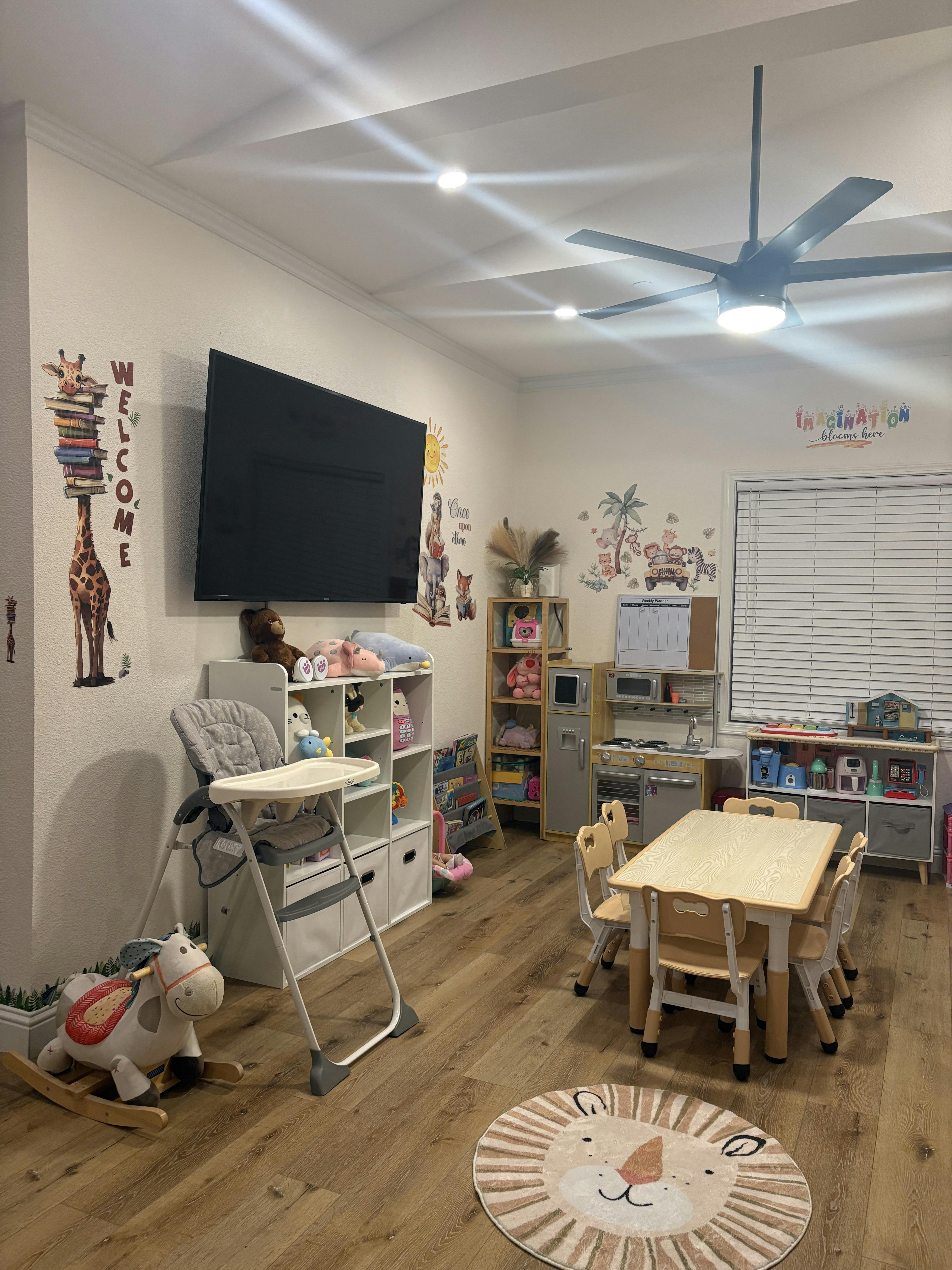 Playroom with a small table and chairs, high chair, and toy shelves
