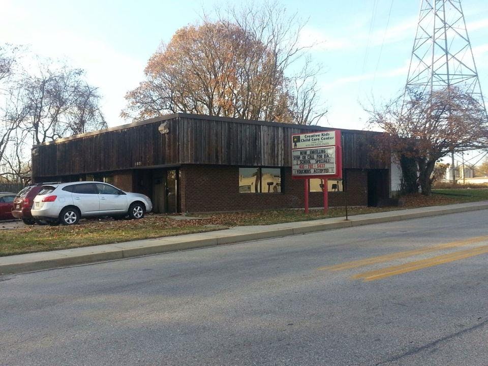Building with a sign and parked cars