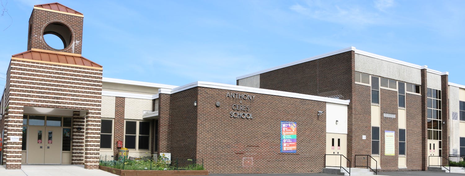 Exterior of a brick building with a tower and multiple entrances