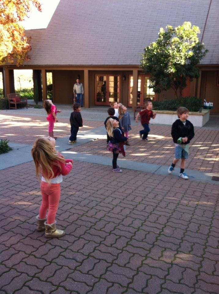 Children playing outdoors on a paved area