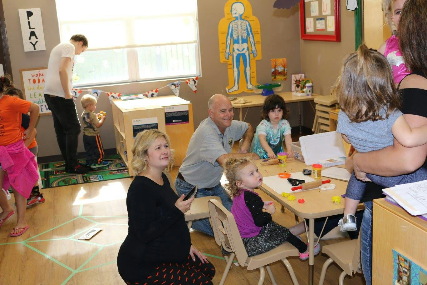 Adults and children in a classroom