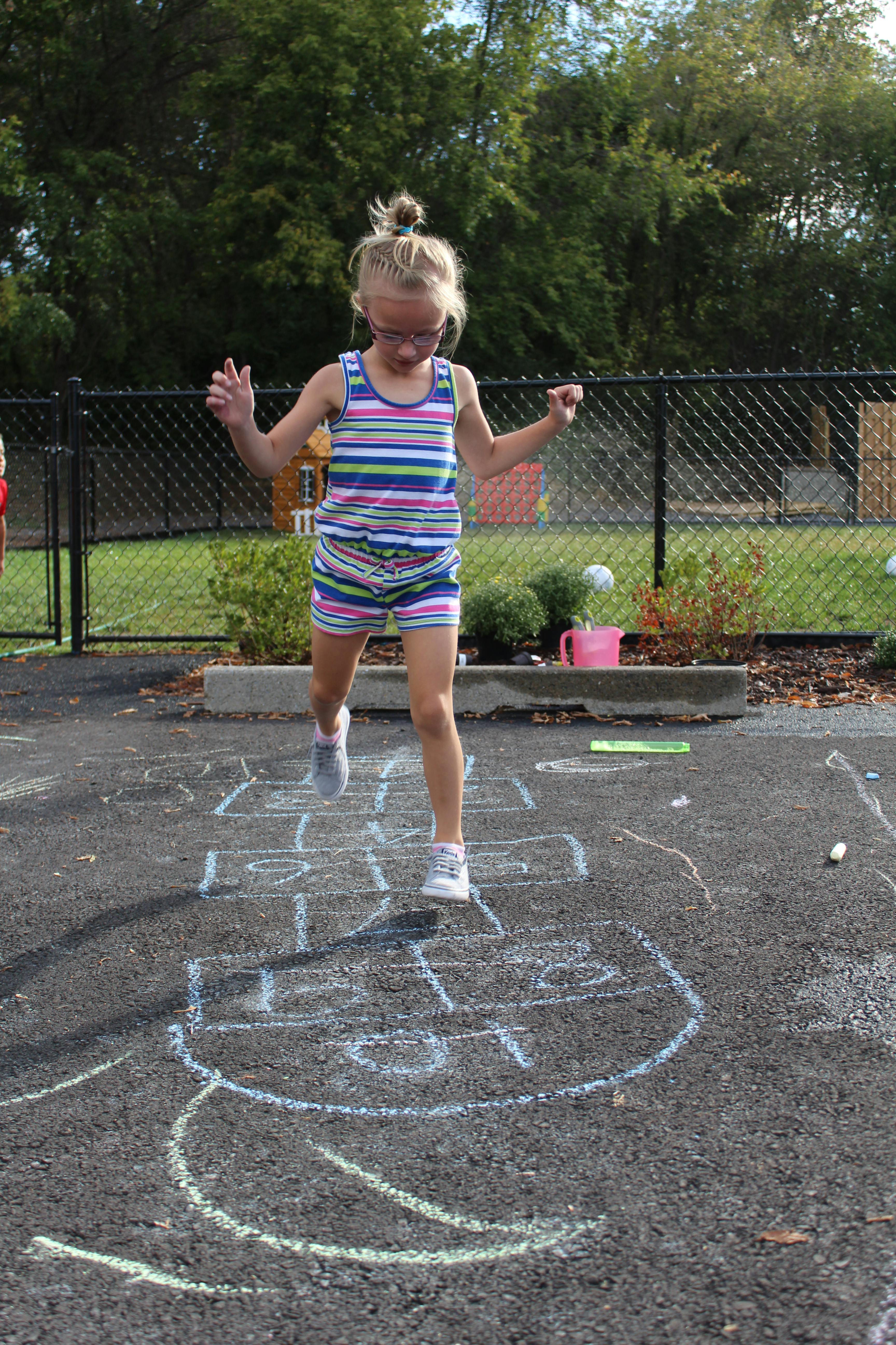 Child playing hopscotch outdoors