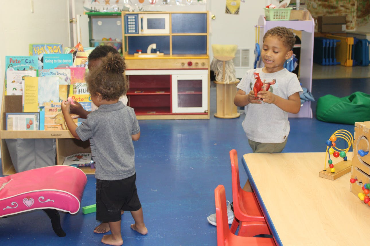 Two children playing in a classroom