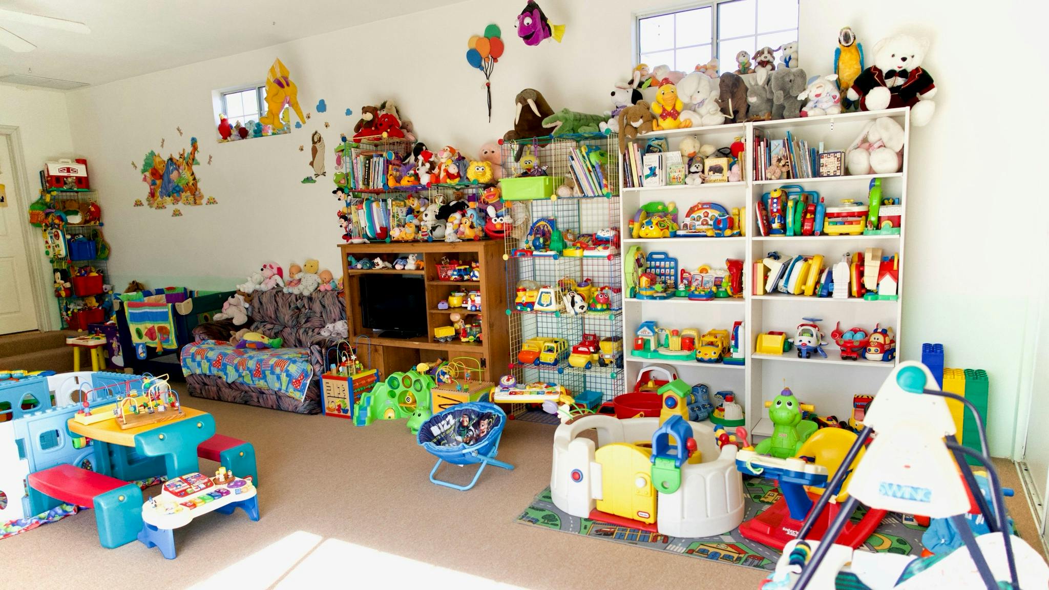 Playroom filled with shelves of toys and play equipment