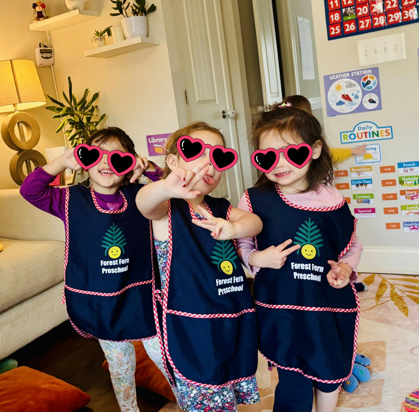 Three children in aprons and heart-shaped sunglasses