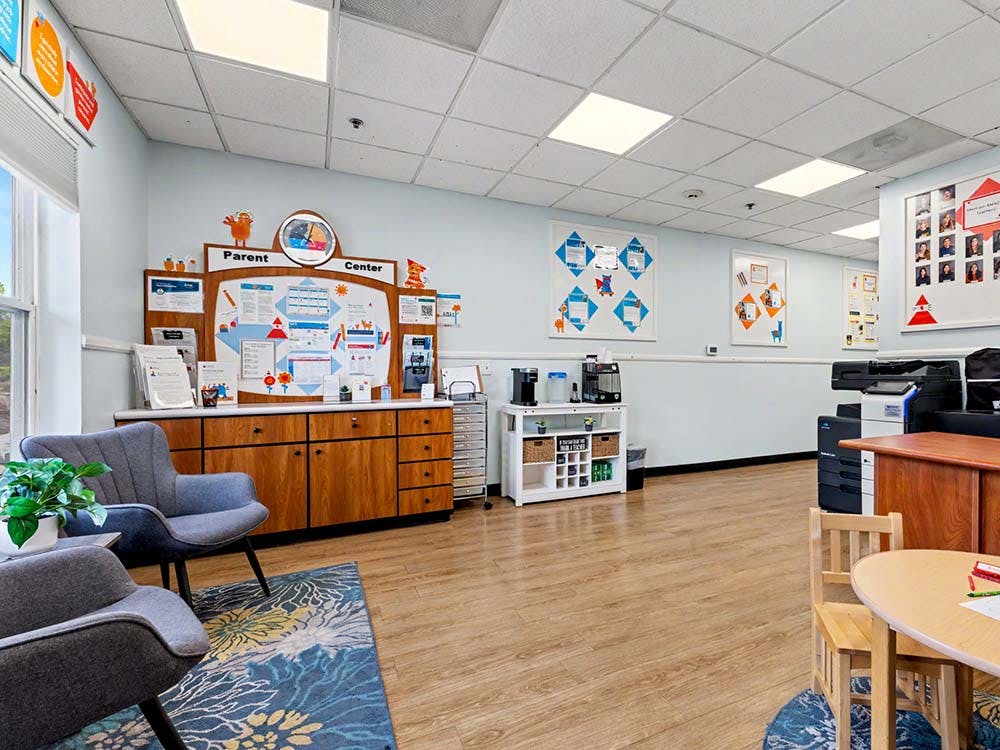 Parent Center room with chairs, an information board, and a coffee station