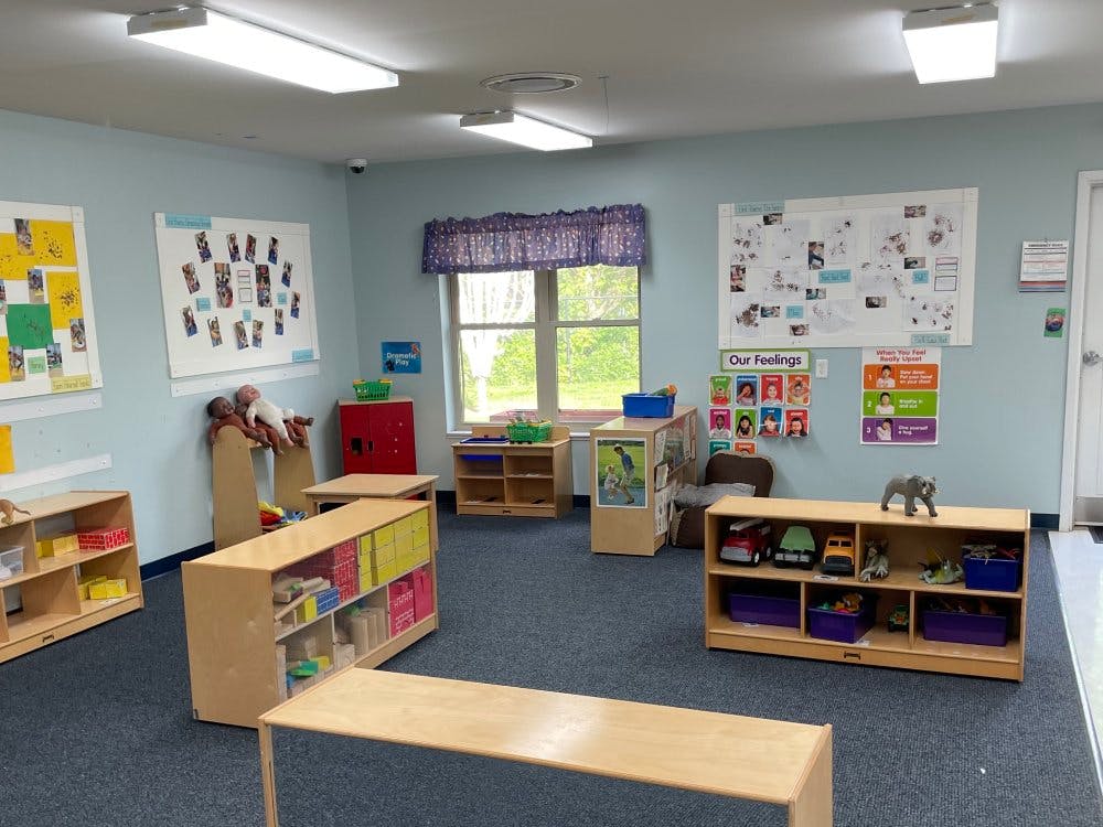 Classroom with shelves of toys, bulletin boards, and a window