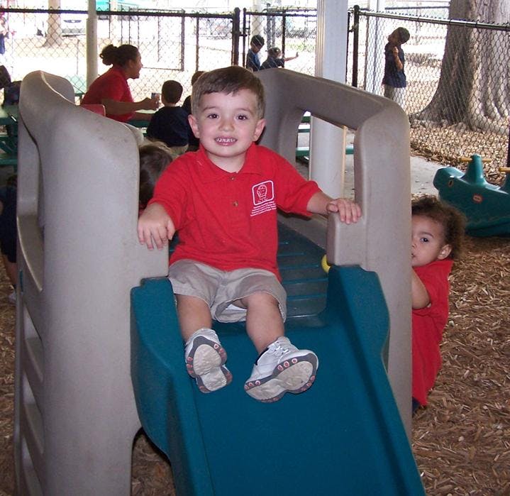 Child sitting on a playground slide