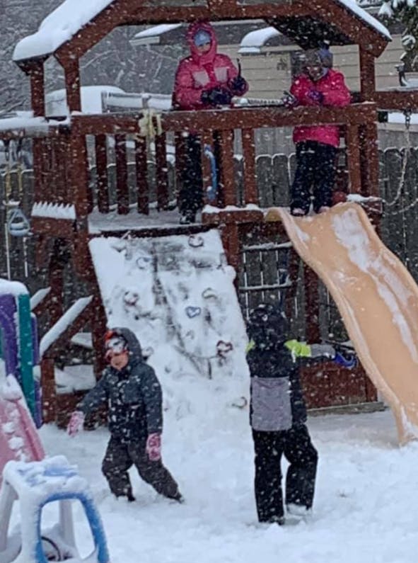 Children playing on a snow-covered playground