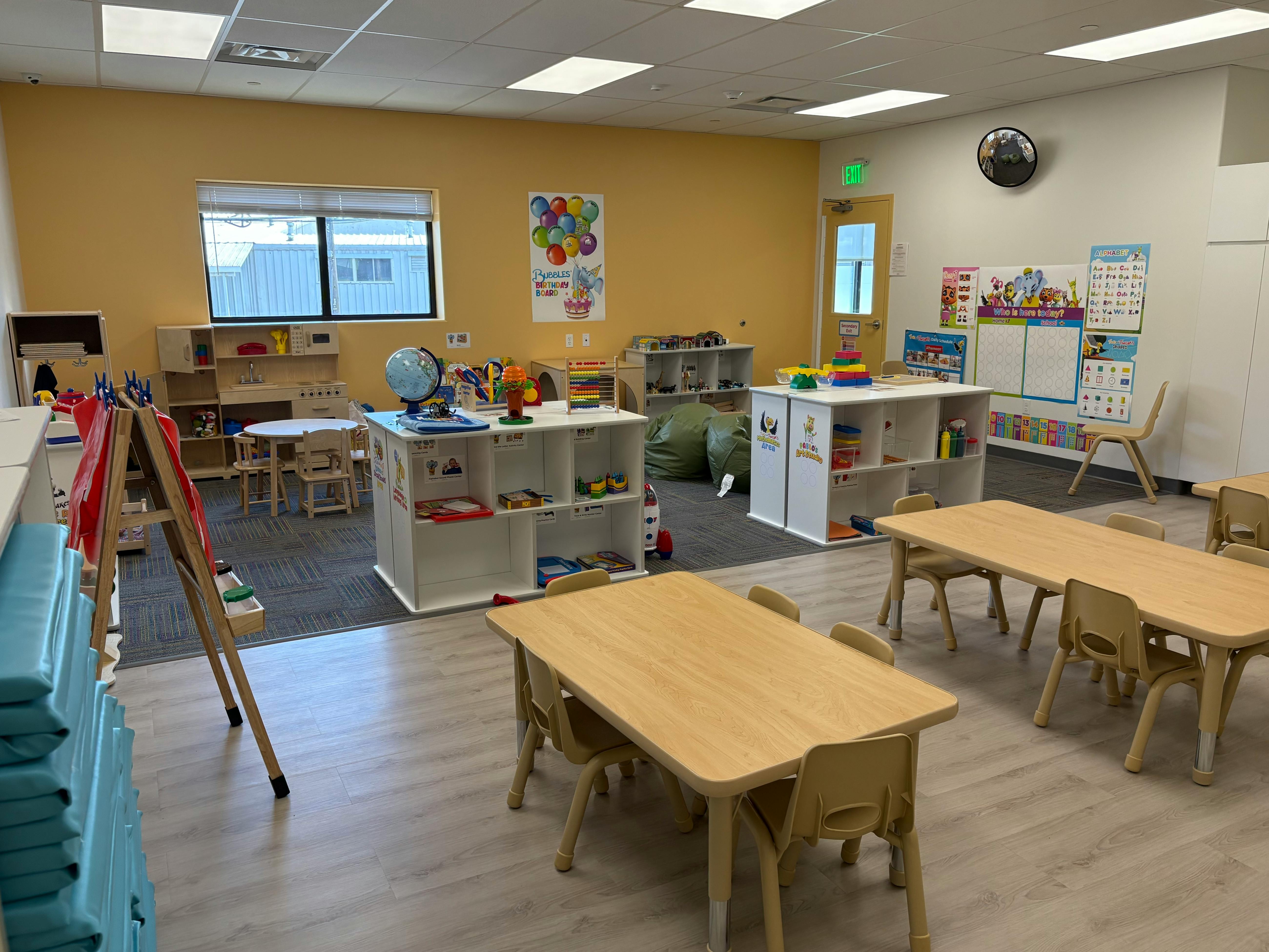 Empty classroom with small tables and chairs