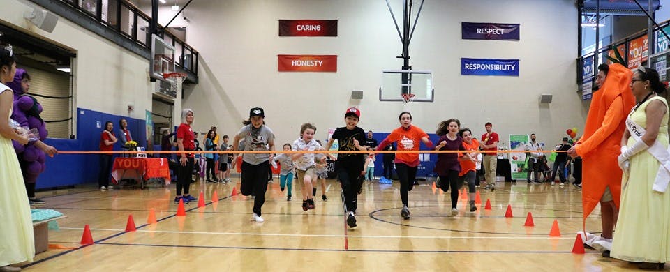 People running a race in a gymnasium
