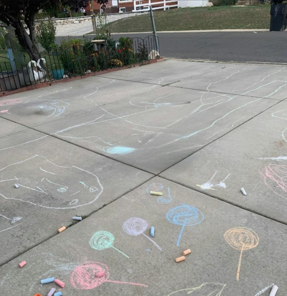 Colorful chalk drawings on a concrete driveway
