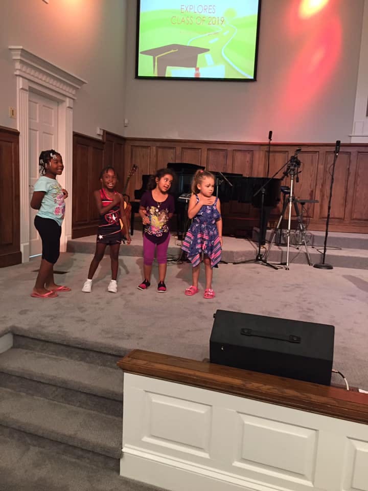 Four children standing on a stage