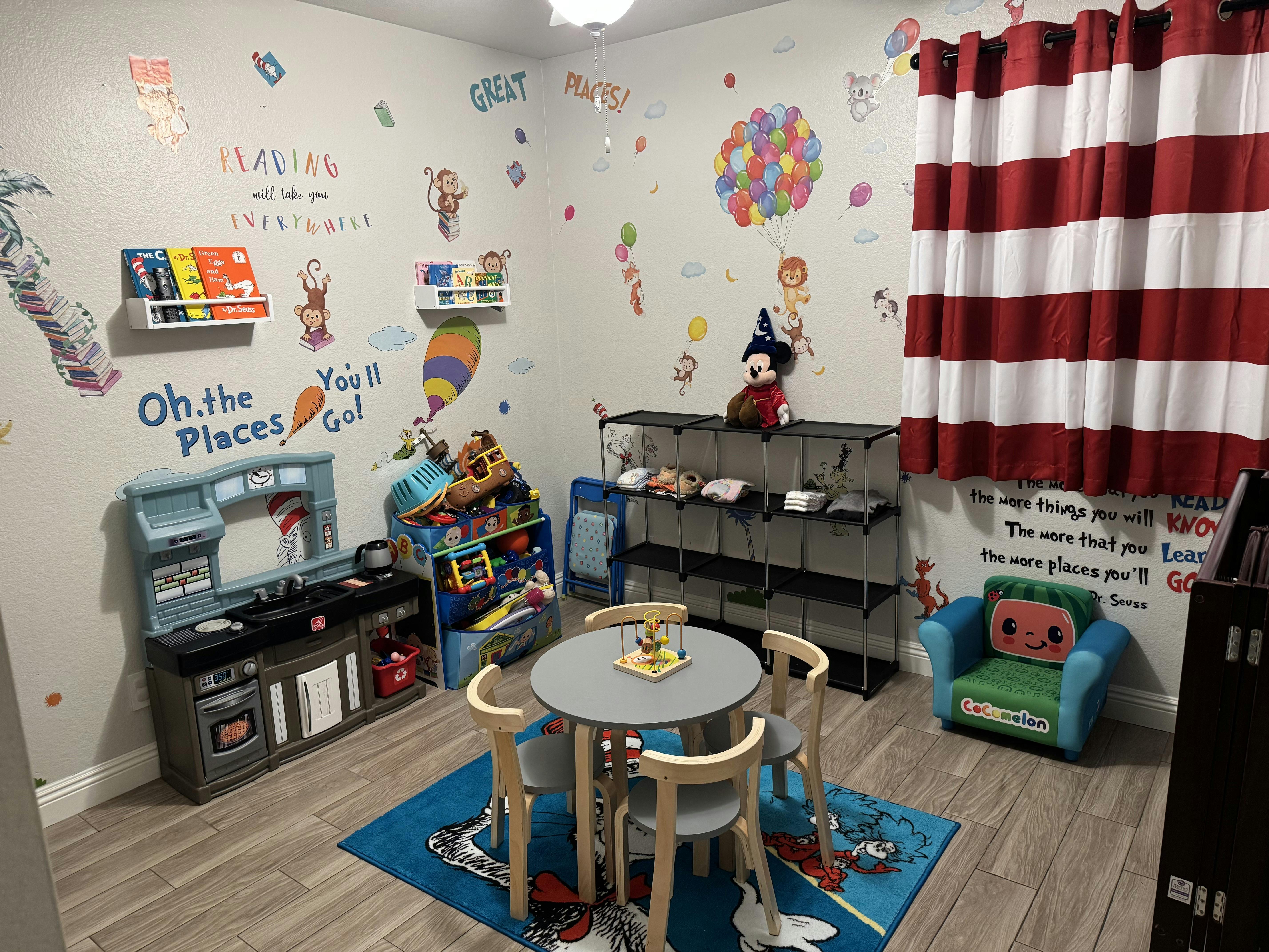 child's play area with Dr. Seuss themed decor and play kitchen
