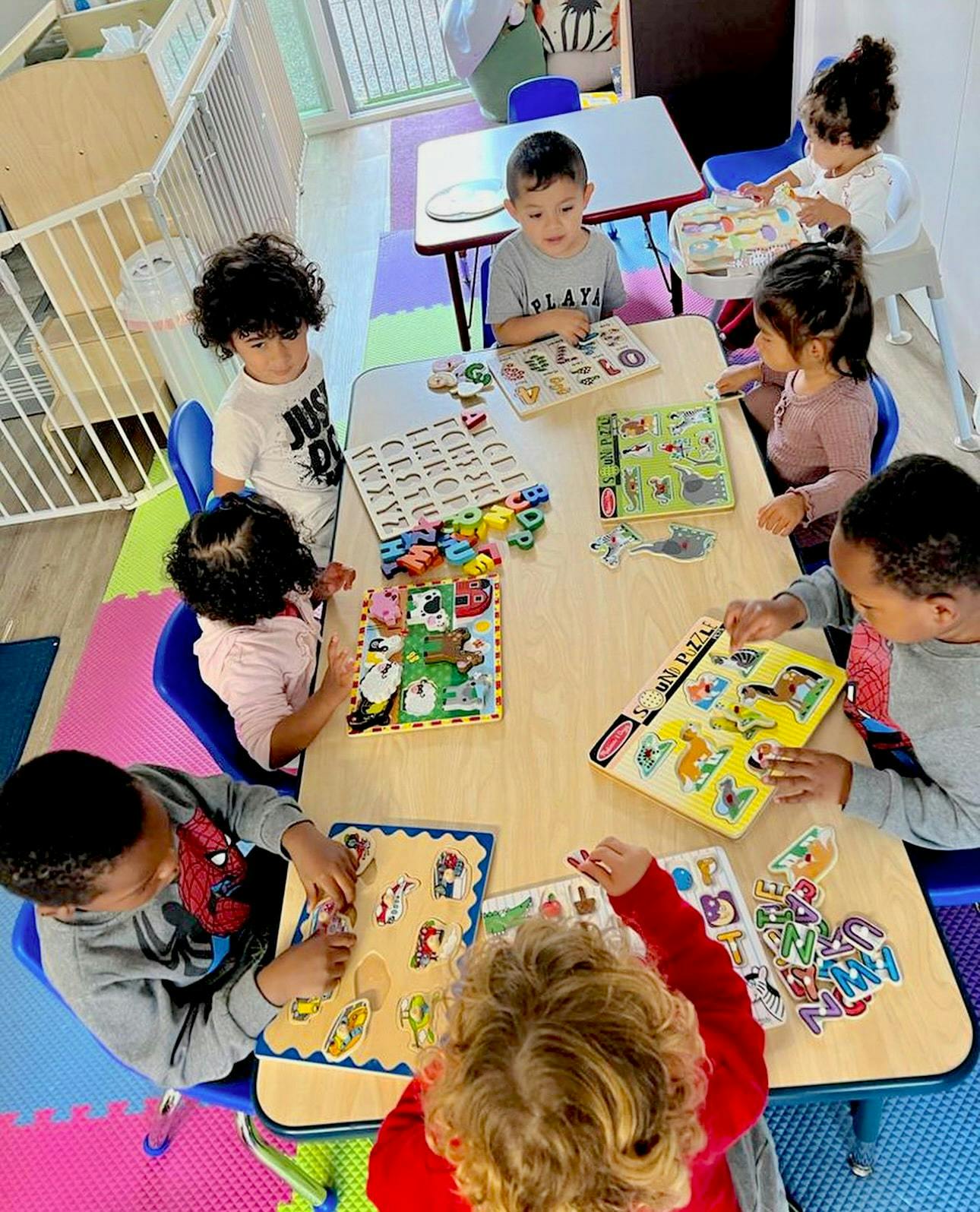 Children playing with puzzles and learning toys at a table