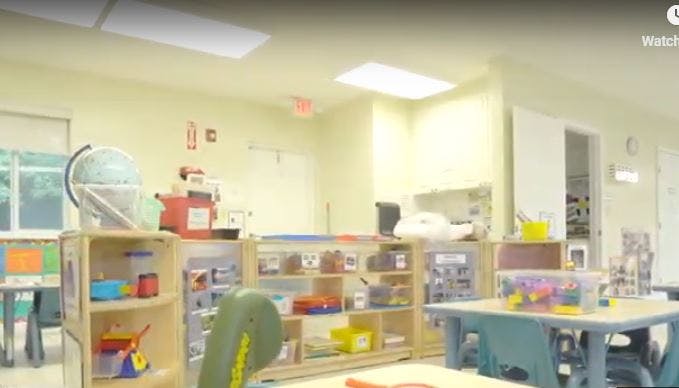Classroom with shelves of supplies and tables