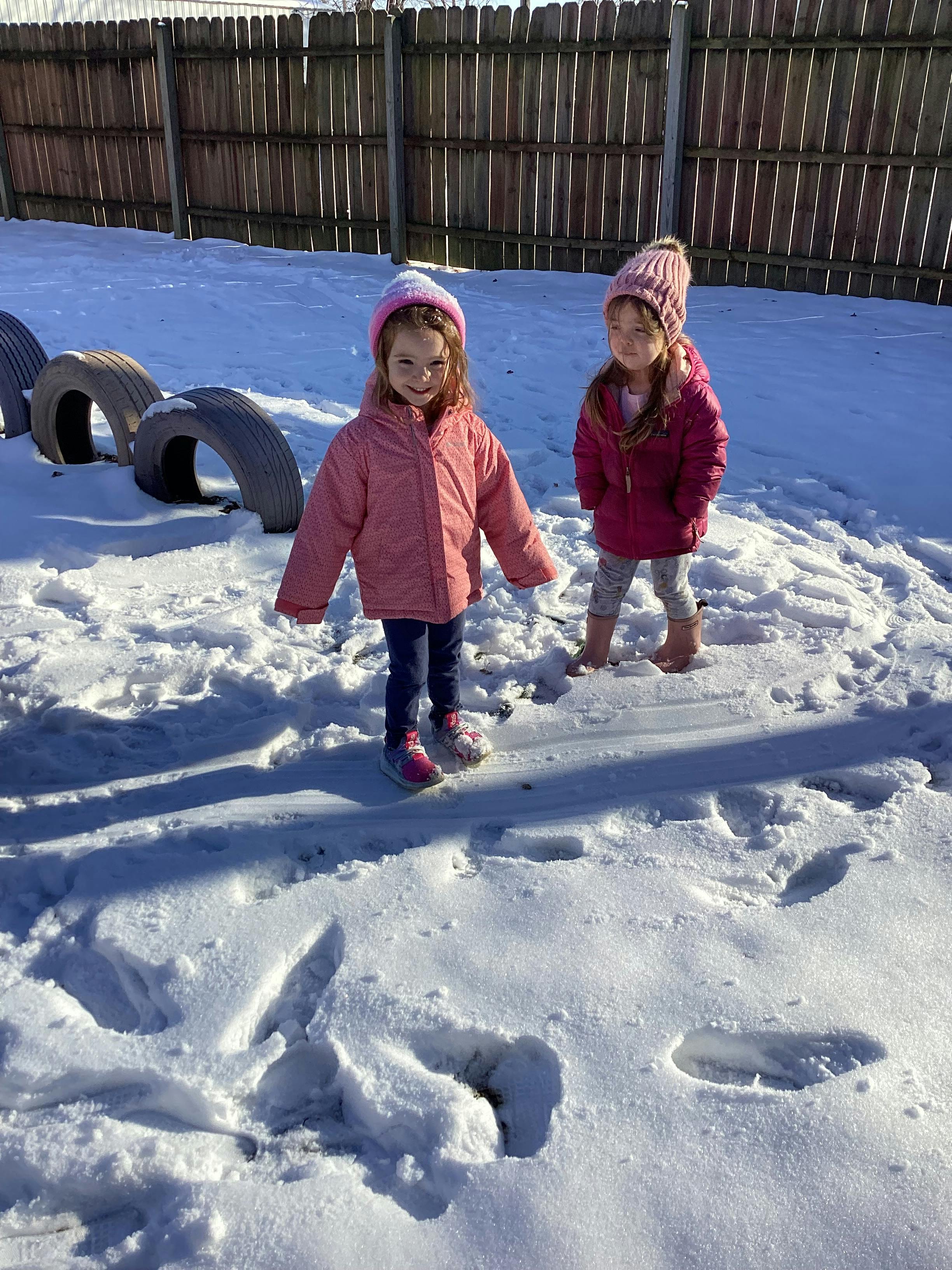 Two children standing in snow