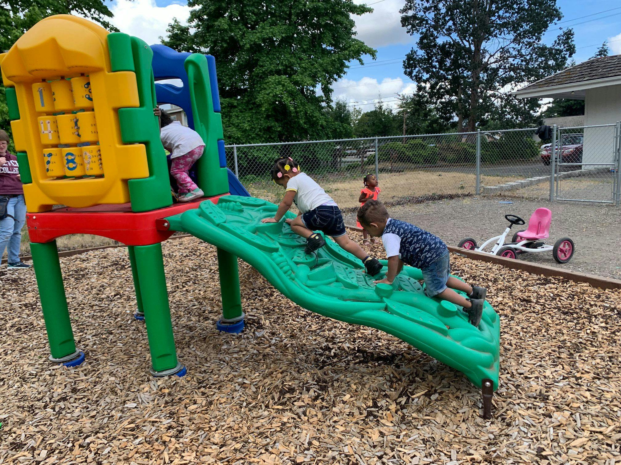 Children playing on a colorful playground structure