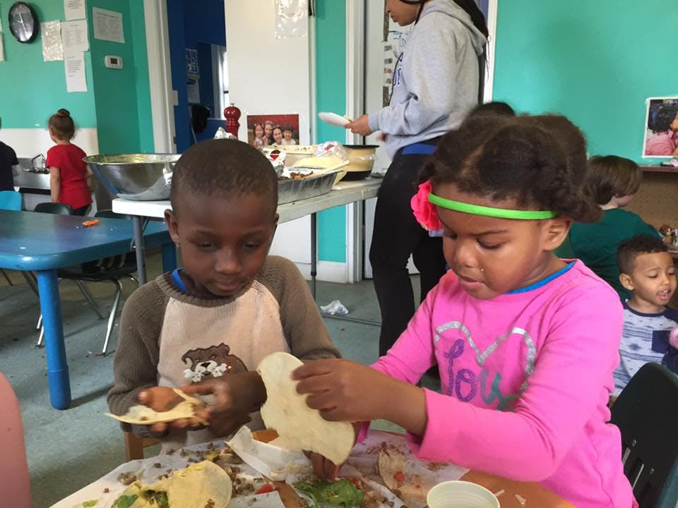 Two children making food at a table