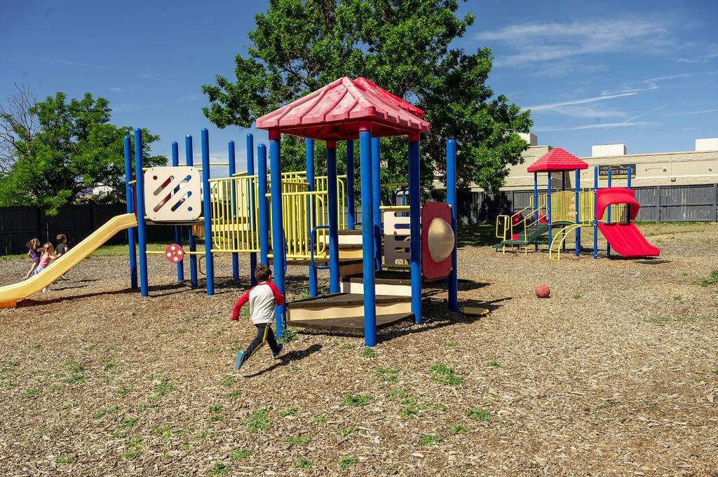 Children playing on playground equipment outdoors