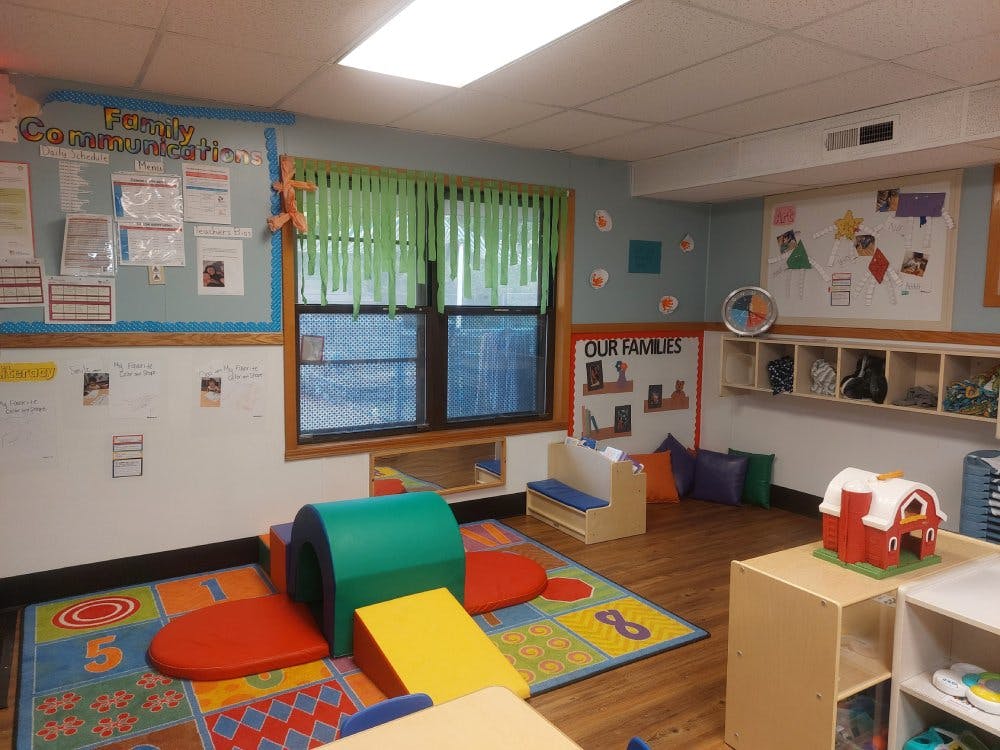 Children's classroom with soft play equipment on a colorful rug