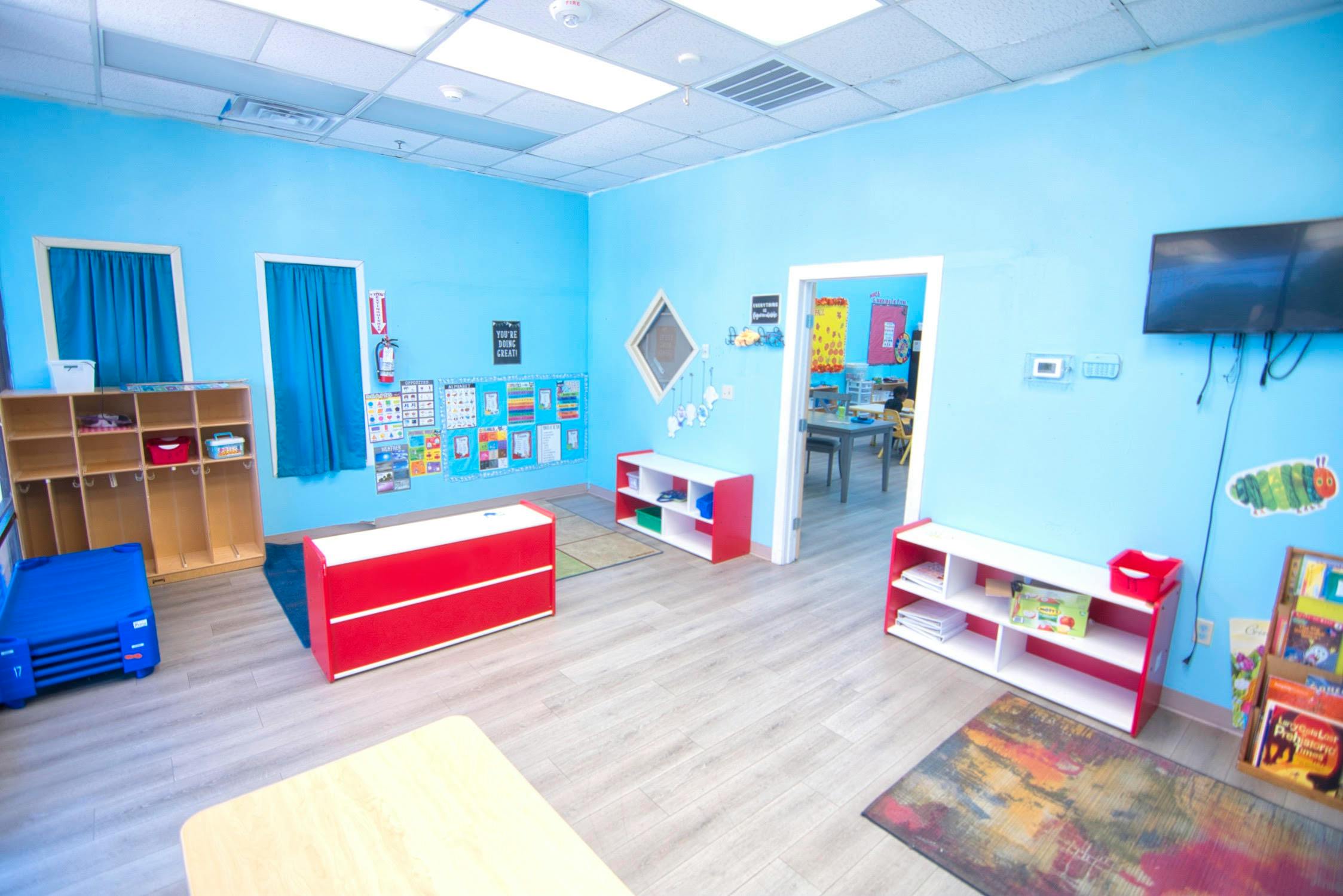 Empty classroom with blue walls and various storage units