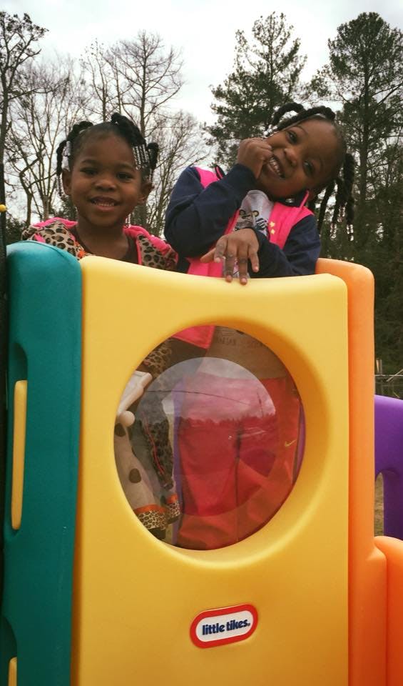 Two children on a colorful playground structure