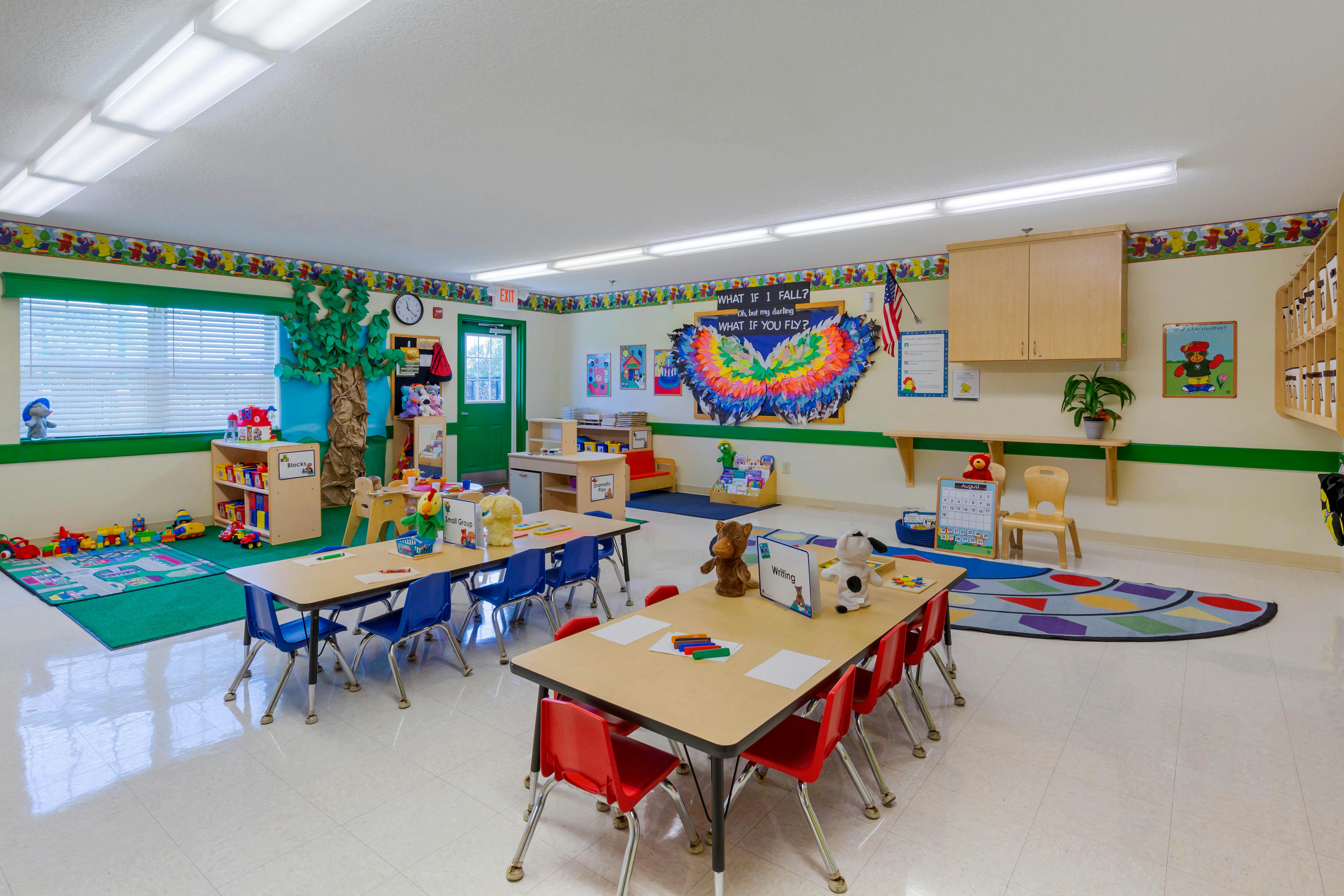 Classroom with child-sized tables and chairs, toys, and decorations