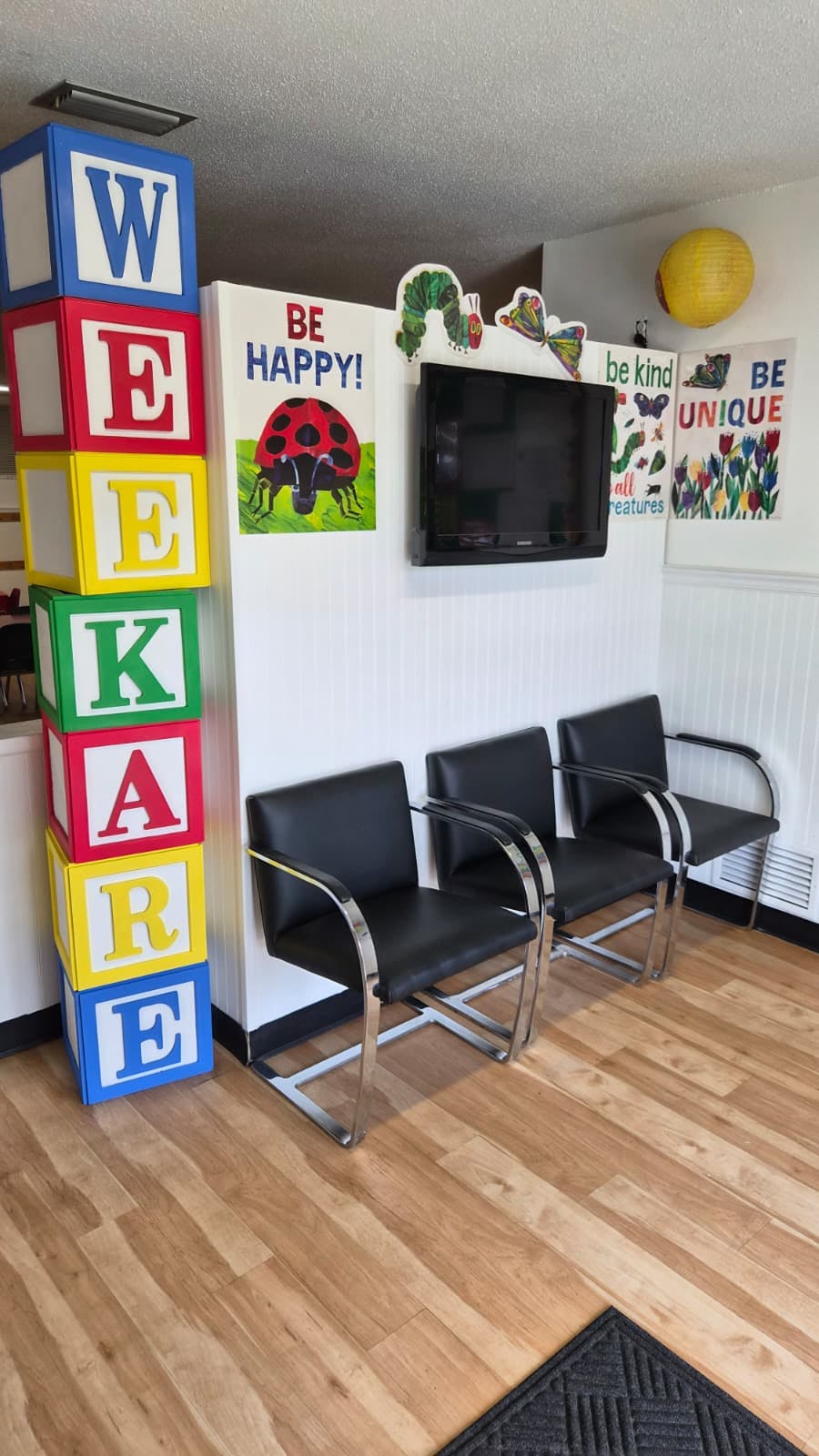 Waiting room with a large stack of letter blocks and a row of chairs