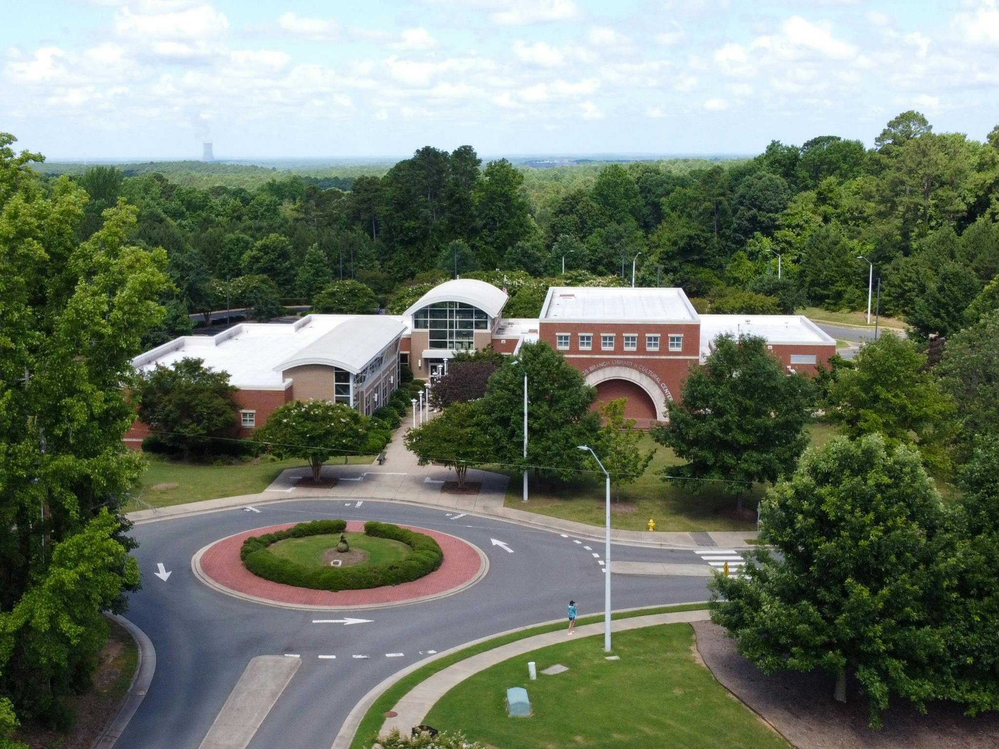 Aerial view of a campus with a circular drive and buildings surrounded by trees
