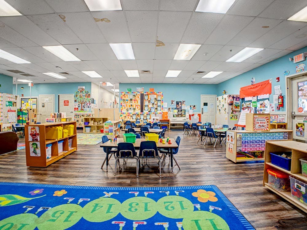 Classroom with tables, chairs, and colorful decorations