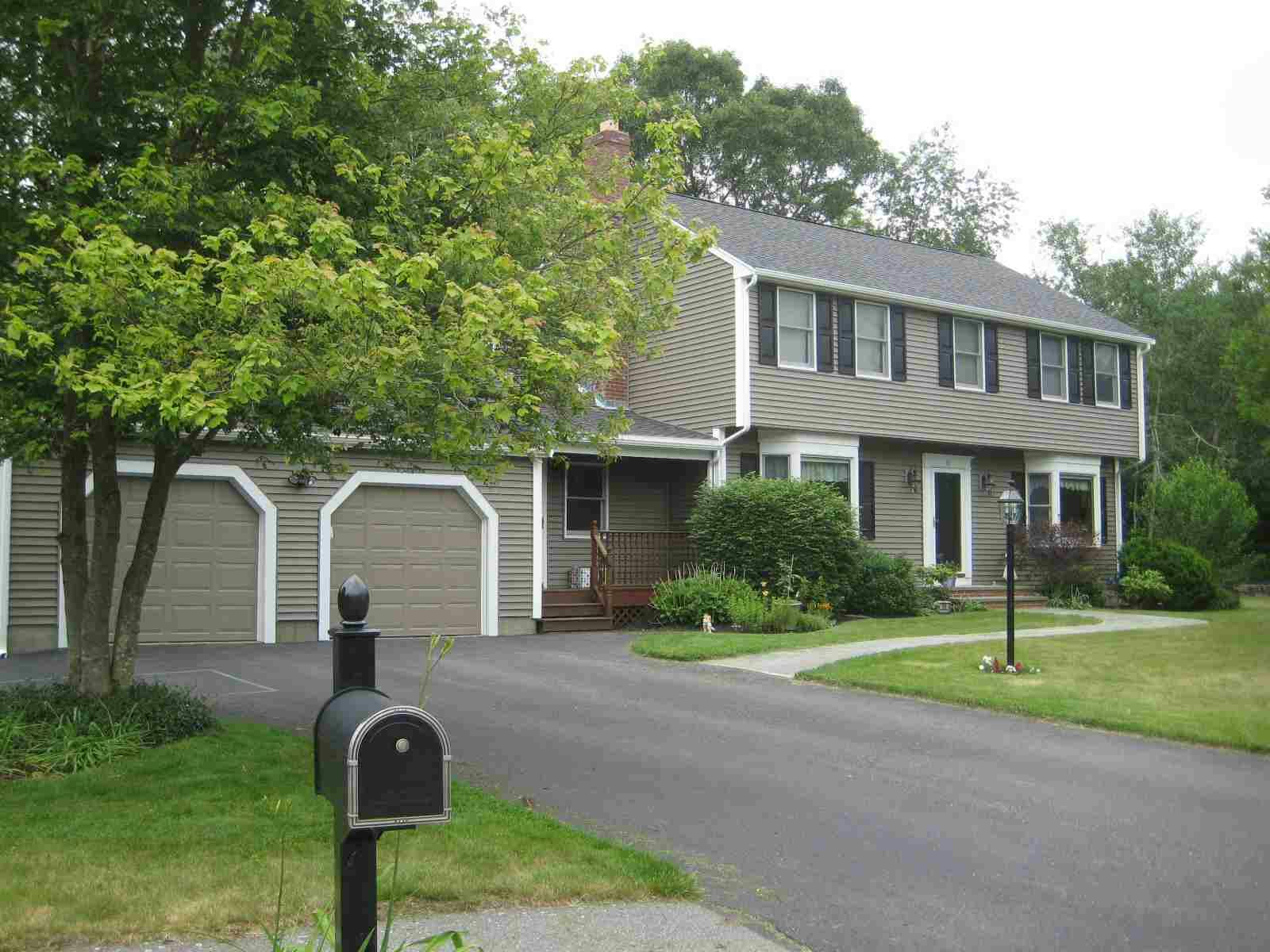 Two-story house with two-car garage and a long driveway