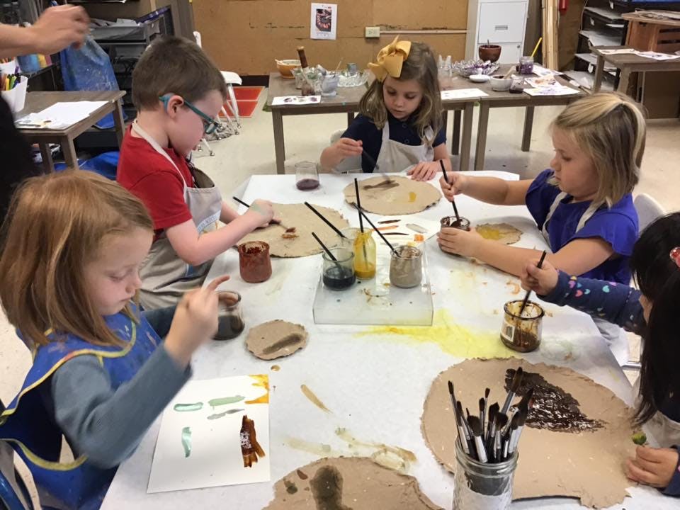 Children painting at a table