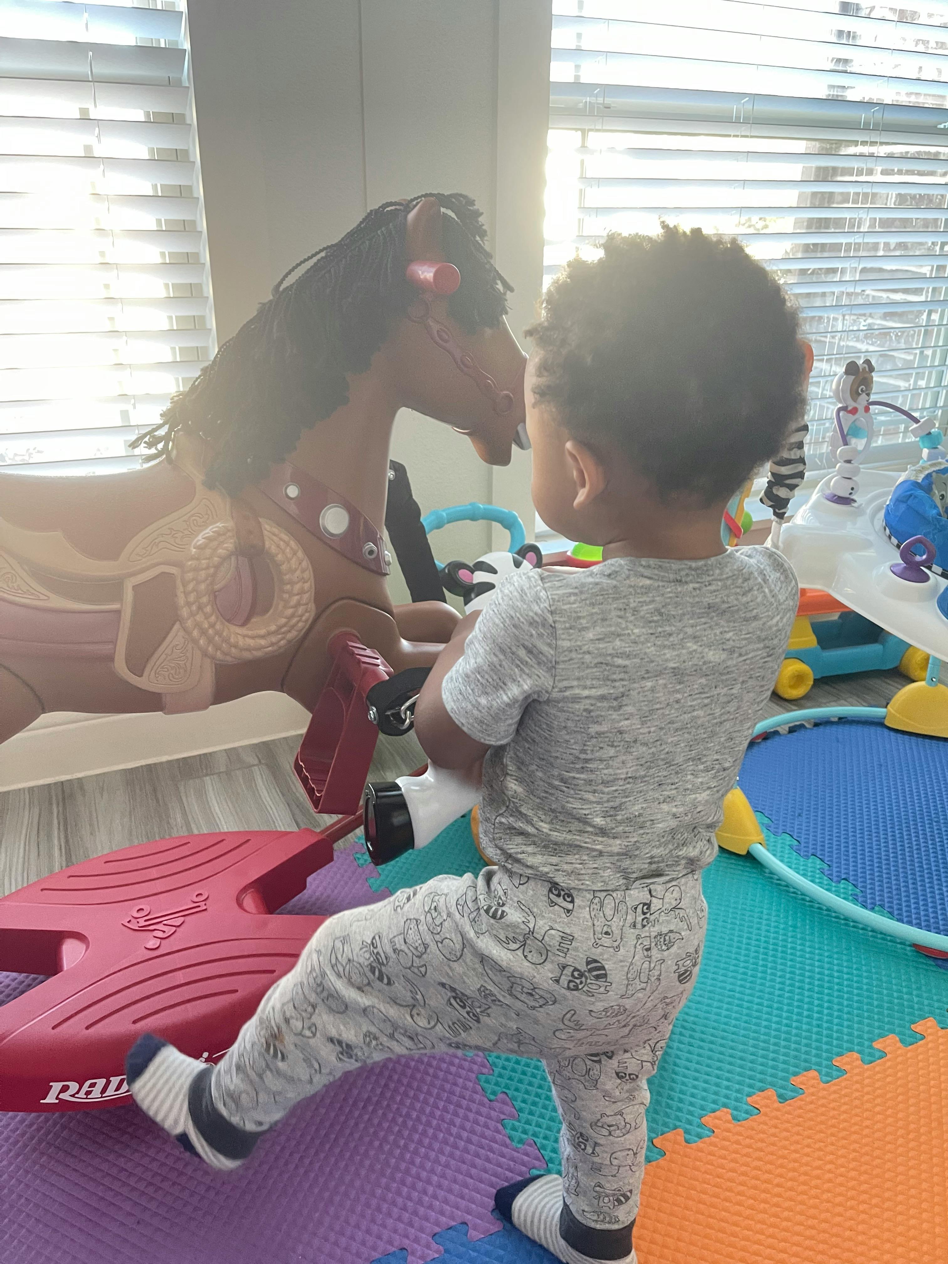 Child playing with a rocking horse