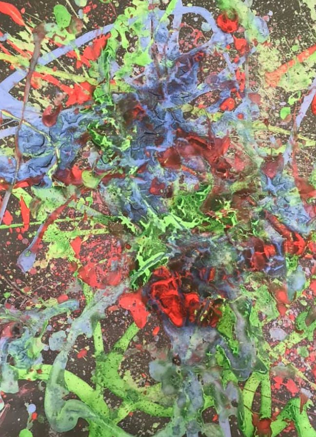Abstract painting with splatters of red, green, and blue paint
