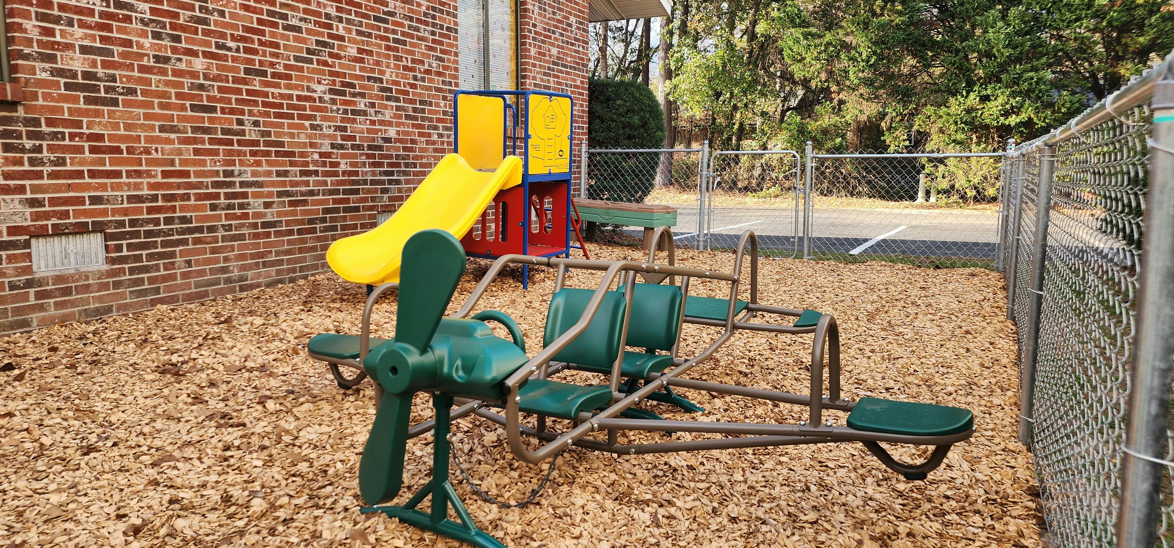 Playground equipment including a slide and a four-seater teeter-totter