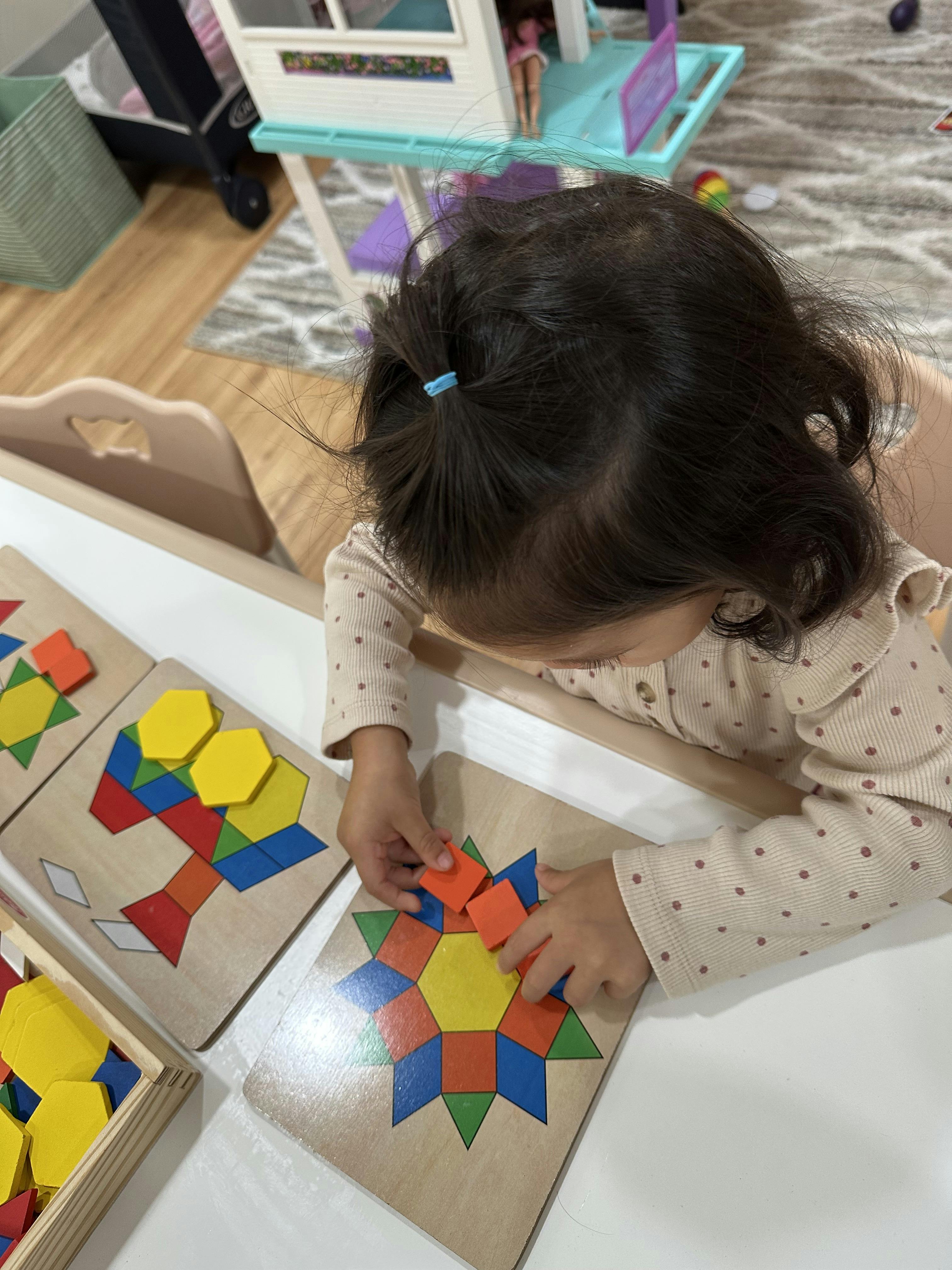 Child playing with colorful geometric shape puzzles