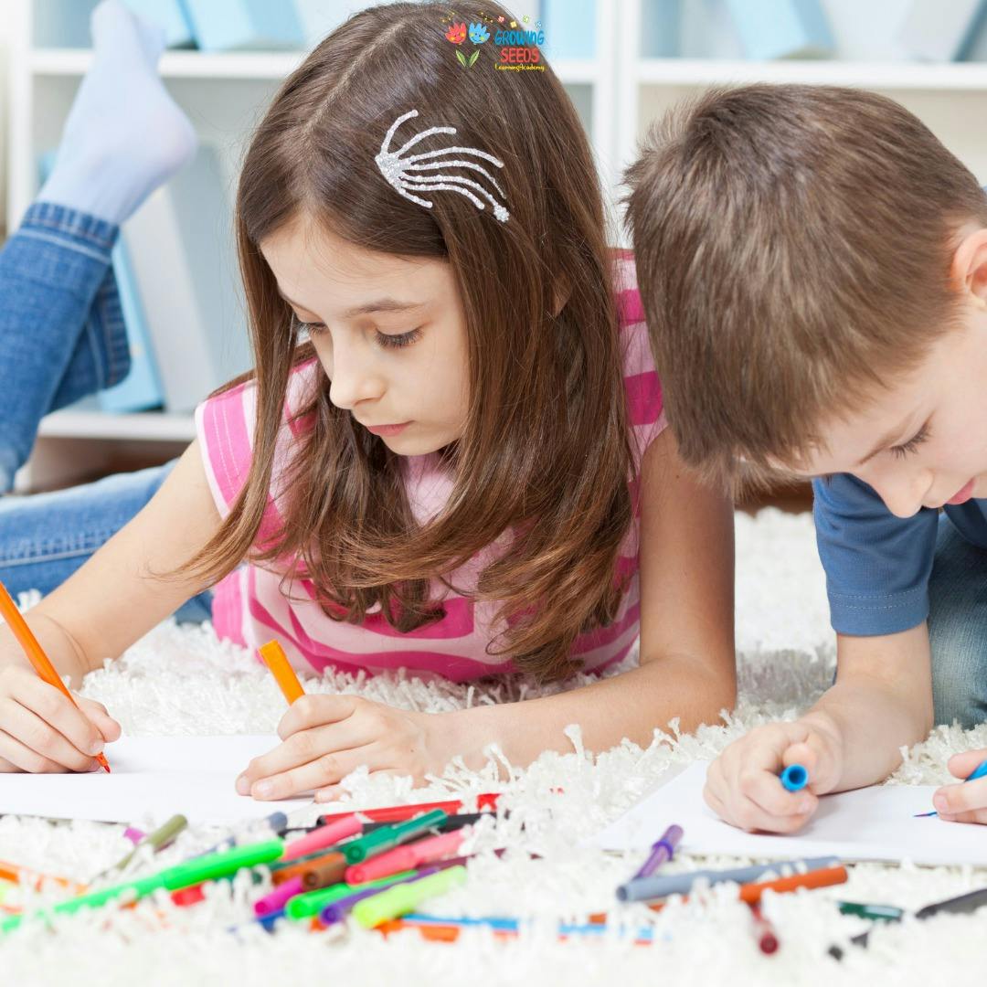 Two children drawing on paper with markers