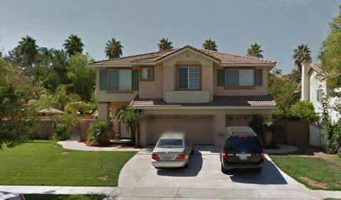 Two-story house with two cars in the driveway