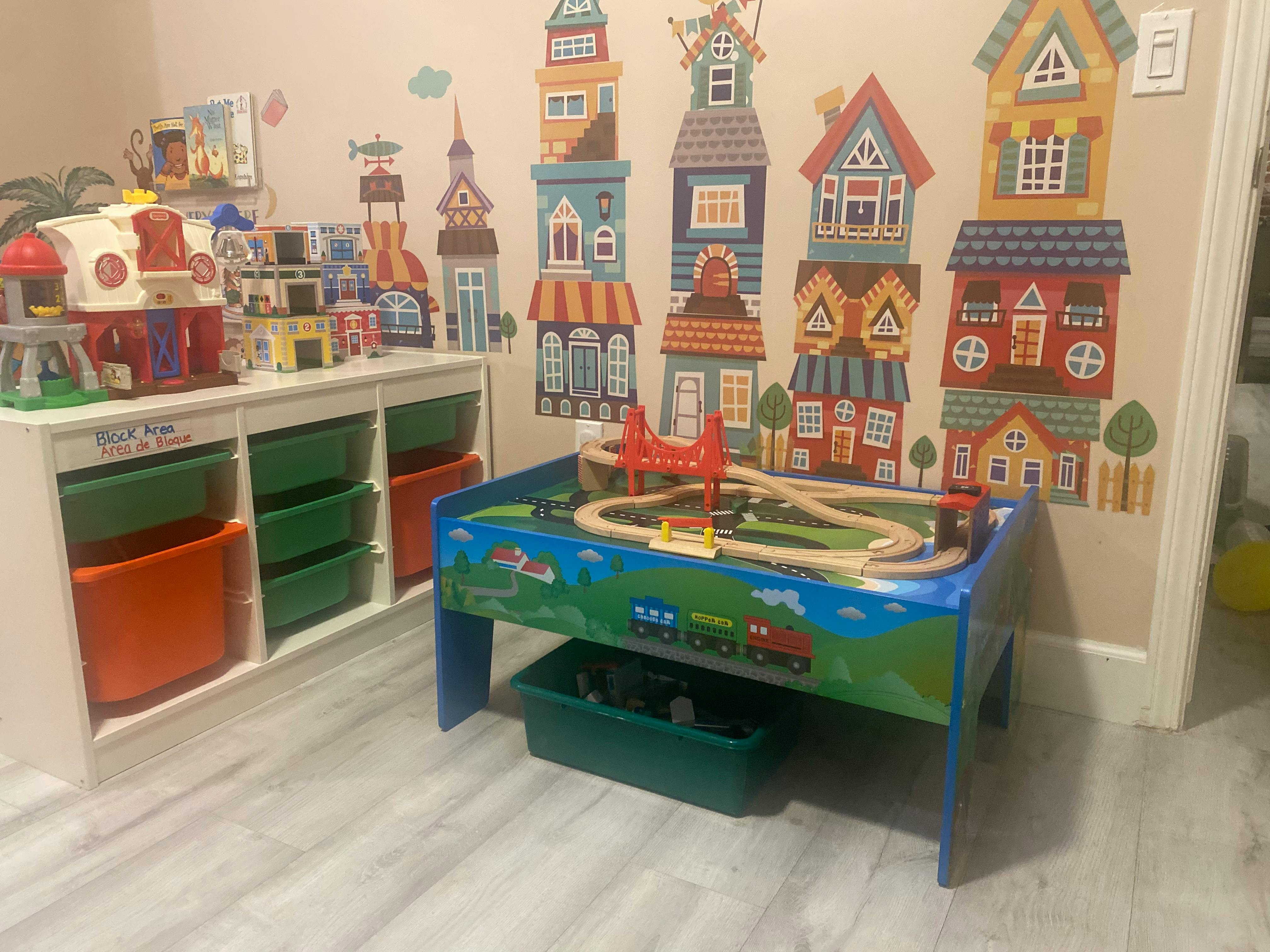 Playroom with a toy train table and storage bins