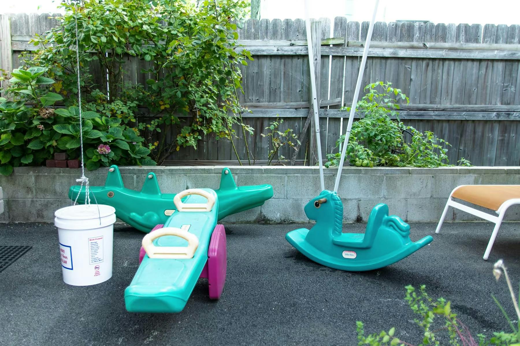 Children's outdoor play equipment including a seesaw and rocking horse