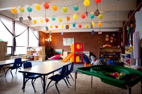 Empty classroom with tables, chairs, and colorful decorations