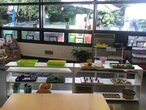 Classroom with shelves of learning materials and large windows