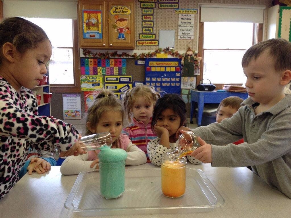 Children doing a science experiment in a classroom