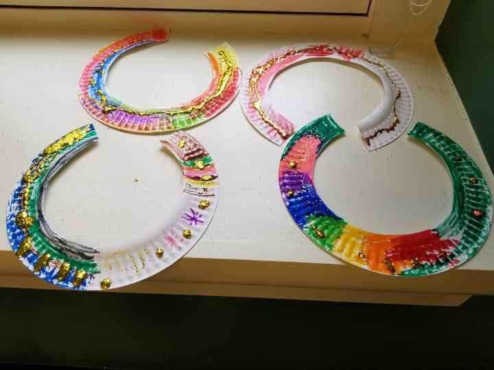 Four colorful paper plate horseshoe crafts