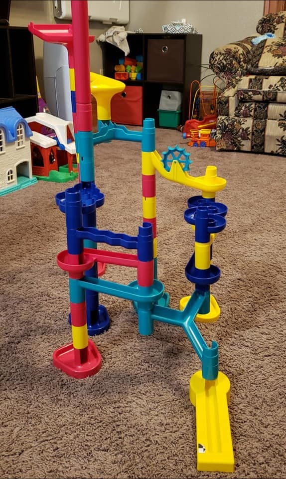 Colorful marble run toy on a carpeted floor
