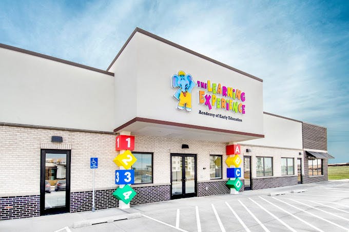 Exterior of The Learning Experience building with colorful sign and number blocks